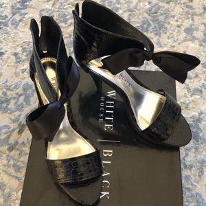 Exquisite black pumps with bow detail.